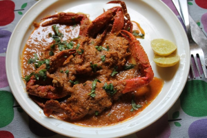 Crab curry dish showing popular sea food names and types of seafood.