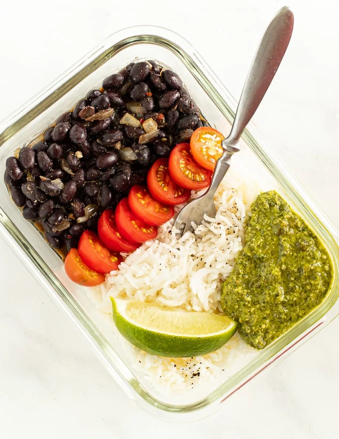 Meal prep container filled with brown rice and black bean salad