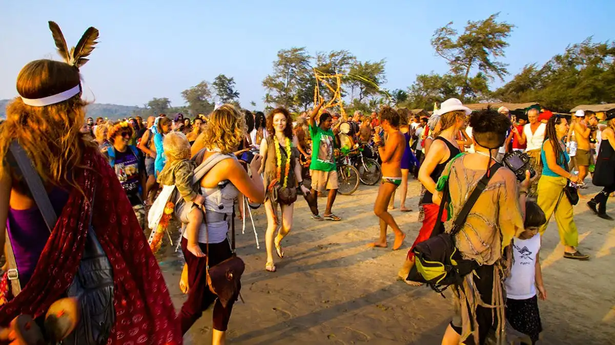 people enjoying a lively day by the sea and palm trees