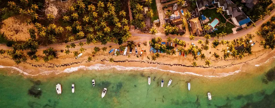 Cabo de Rama with aerial view of sandy coastline, palm trees and sea and boat ...