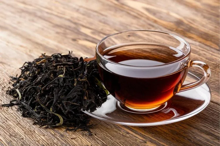 black tea cup and leaves