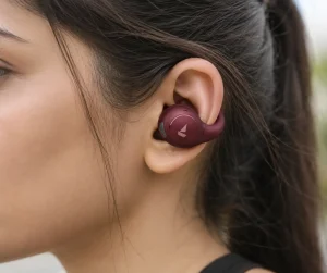 Person wearing boAt Airdopes ProClip OWS open-ear wireless earbuds showing clip-on design and open-ear fit