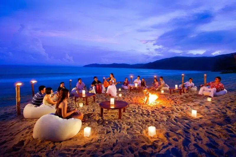 party with people enjoying a lively evening at Colva Beach by the sea..