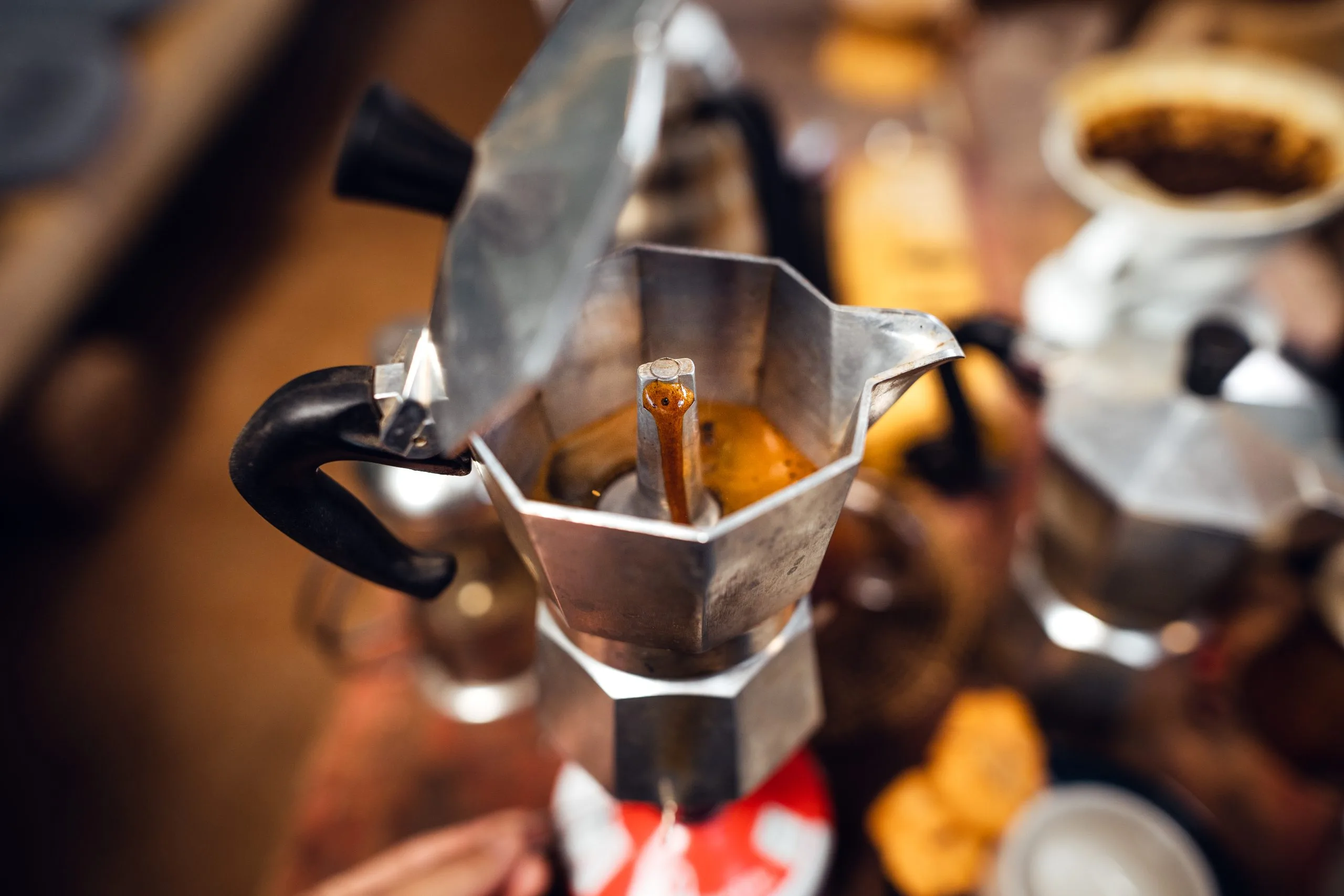 Traditional italian moka pot brewing rich coffee, with instant coffee as another convenient way to enjoy a strong drink