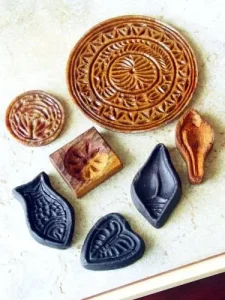 Traditional handmade clay moulds for festive crafts.