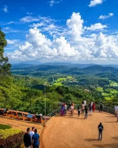 Panoramic view of green valleys and distant hills from Raja's Seat in Madikeri, Coorg.