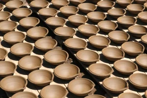 Rows-of- handmade-clay-diyas-drying- in-the-sunlight- before- being-fired-in-a-kiln