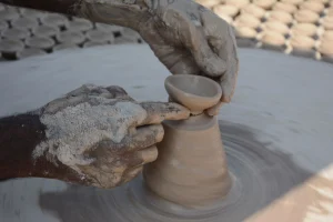 An-Indian-potter- shaping-a- traditional-clay- diya-by-hand-on-a- pottery-wheel